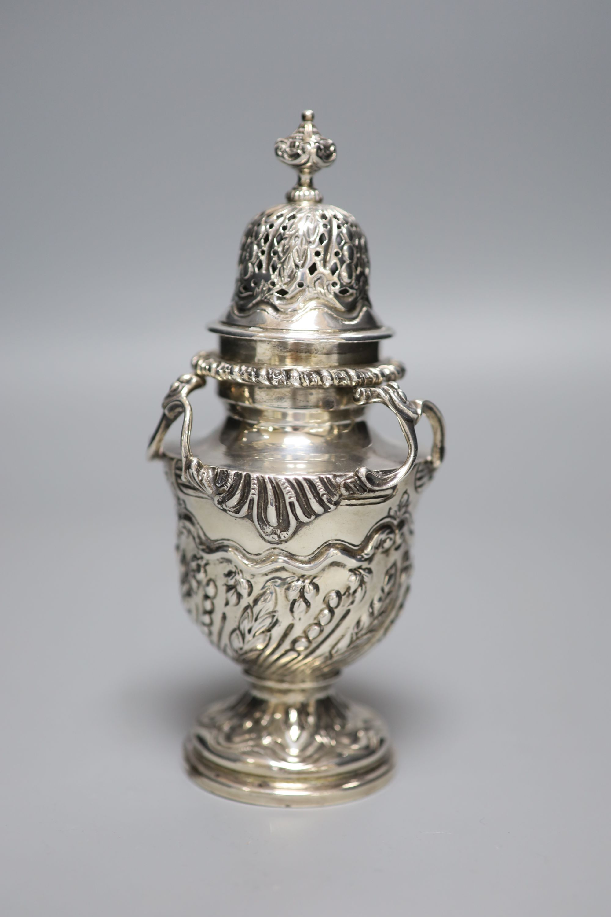 An ornate late Victorian silver sugar castor by William Comyns, London, 1897, 16.2cm, 7oz.